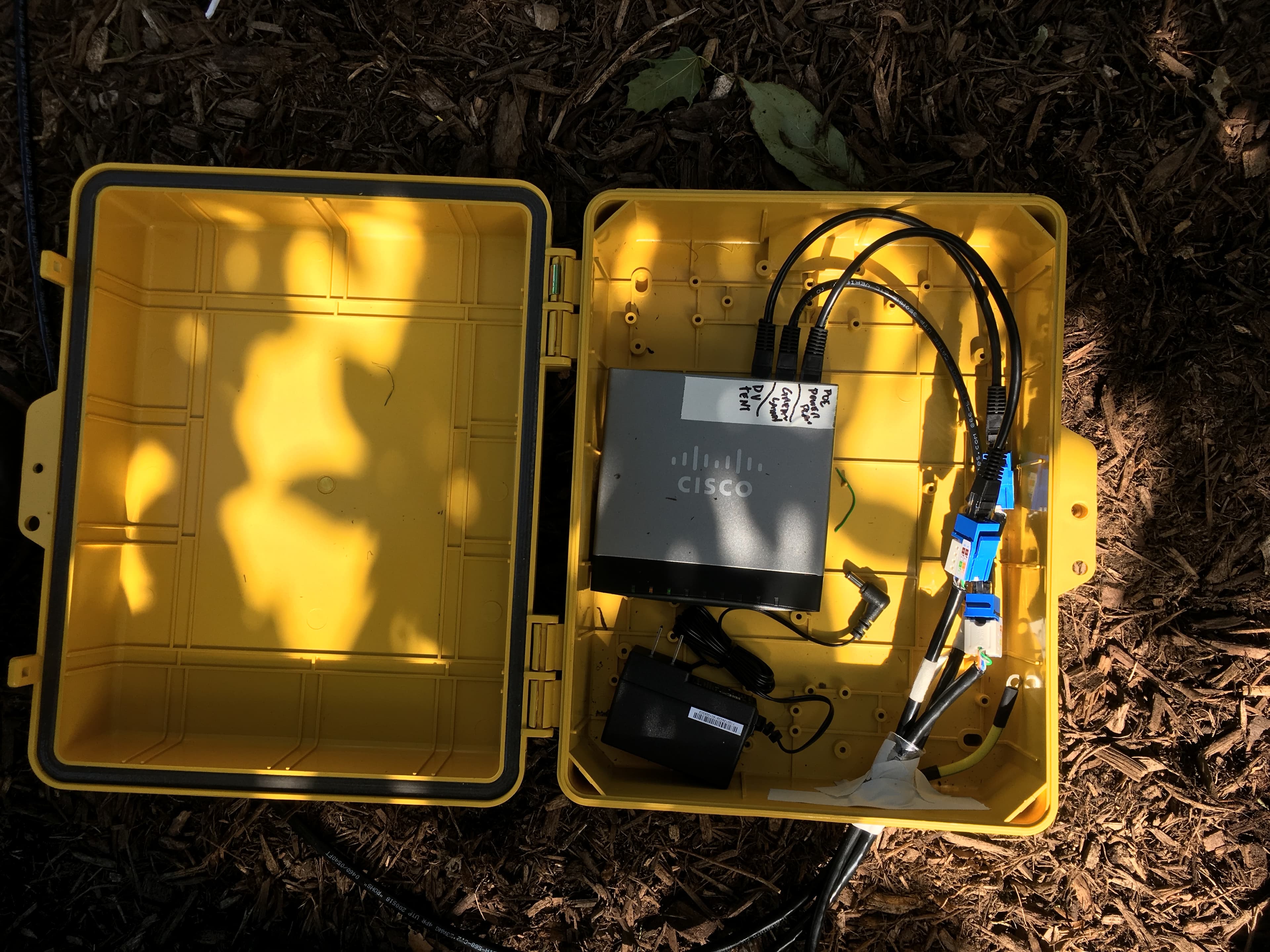 Sealed Pelican case PoE relay deployed at the edge of the Great Lawn at Snug Harbor